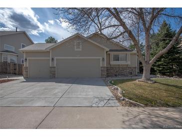 Charming home featuring a three-car garage and stone accents on the exterior at 271 Terra Vista St, Brighton, CO 80601
