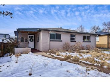 Cute ranch home with a white door and snowy front yard at 2651 Perry St, Denver, CO 80212