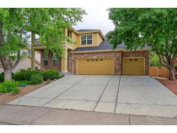 Inviting two-story home featuring a brick facade, a spacious driveway, and well-maintained landscaping at 2631 E 136Th Pl, Thornton, CO 80602