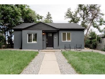 Charming single-story home with a well-maintained front yard and a walkway leading to the front door at 1361 W Custer Pl, Denver, CO 80223