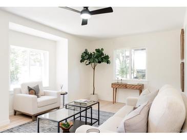 Open living room featuring leafy tree, light, and comfortable furniture at 1361 W Custer Pl, Denver, CO 80223