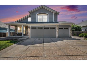 Charming two-story home featuring a two-car garage and covered porch entrance at 6833 E 115Th Ave, Thornton, CO 80233