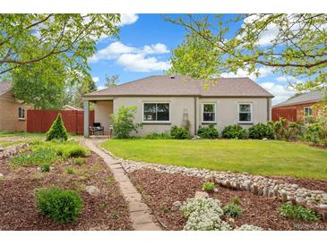 Charming single-story home boasts a landscaped front yard with a stone pathway at 2965 Ivy St, Denver, CO 80207