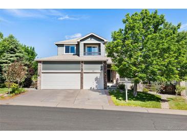 Charming two-story home with a three car garage, and mature landscaping at 9745 Hummingbird Pl, Littleton, CO 80125