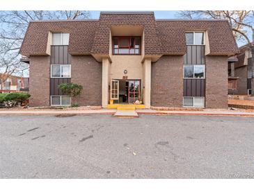 Attractive building exterior, featuring a classic design and landscaping at 7755 E Quincy Ave # 101, Denver, CO 80237