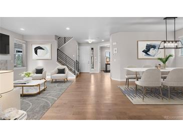 Inviting living space with hardwood floors, a staircase, modern decor, and abundant natural light at 540 E Fremont Pl, Centennial, CO 80122