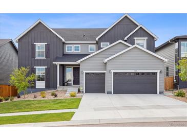 Beautiful two-story home with well-manicured lawn and a two-car attached garage at 14423 Shasta Daisy Ln, Parker, CO 80134