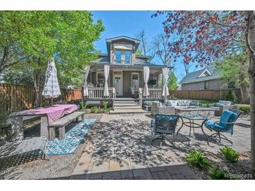 Inviting backyard retreat with stylish patio furniture and a charming covered porch at 1027 S University Blvd, Denver, CO 80209