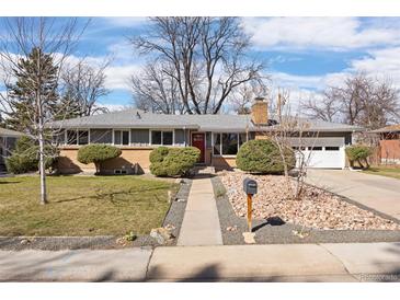 Charming single-story home with a well-manicured lawn, rock garden, and inviting red front door at 991 E Applewood Ave, Centennial, CO 80121