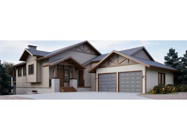 Striking two-story home featuring a three-car garage, stone accents, and craftsman-style details at 680 Lone Eagle Dr, Granby, CO 80015