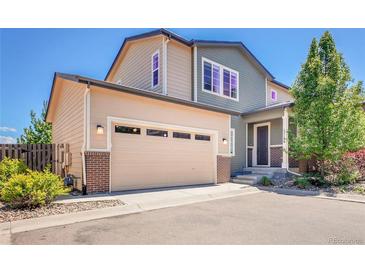 Beautiful two-story home featuring a beige garage door and a blend of beige and green siding at 17186 E Cedar Gulch Dr, Parker, CO 80134