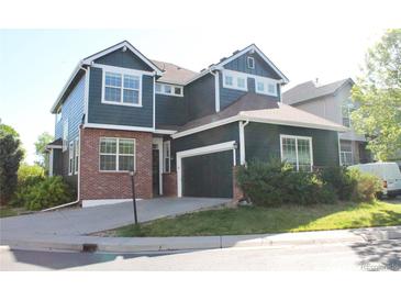 Charming two-story home with a well-maintained lawn and an attached two-car garage at 1710 S Poplar St, Denver, CO 80224