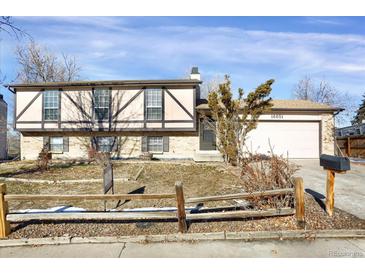 Ranch style home with attached garage and landscaping at 16651 E Arizona Pl, Aurora, CO 80017