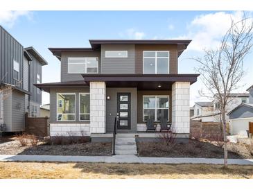 Contemporary two-story home featuring a modern design and inviting front porch at 9976 E 63Rd Ave, Denver, CO 80238