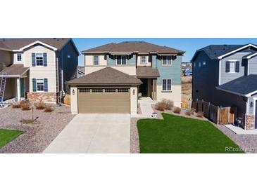 Inviting two-story home with a two car garage, well-manicured lawn, and charming curb appeal at 944 Mcmurdo Cir, Castle Rock, CO 80108