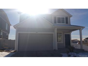 Two-story house with gray siding, attached garage, and small front yard at 20108 Randolph Pl, Denver, CO 80249