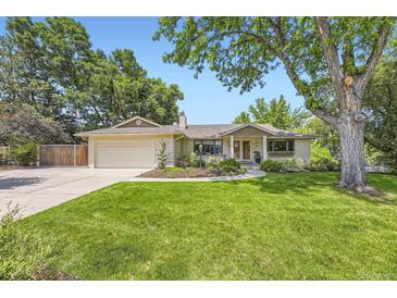 Charming single-story home with a well-manicured lawn and mature trees at 5475 W Ottawa Ave, Littleton, CO 80128