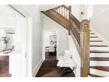 Bright entryway with hardwood floors, bench, and elegant staircase at 3044 W 29Th Ave, Denver, CO 80211