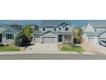 Charming two-story home featuring a three-car garage and well-maintained landscaping at 7665 Grady Cir, Castle Rock, CO 80108
