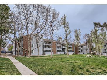 A view of the exterior of the apartment building with brick and painted wood at 14437 E 1St Dr # C09, Aurora, CO 80011