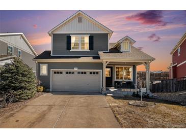 Charming two-story home featuring well-maintained landscaping, attached garage, and inviting front porch at 1698 Odyssey Ct, Castle Rock, CO 80109
