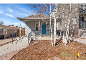 Charming home exterior with a welcoming front porch and vibrant blue door at 1267 Quitman St, Denver, CO 80204