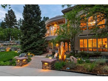 Stunning home exterior with professional landscaping and unique rock water feature at 392 Starmine Pl, Castle Rock, CO 80108