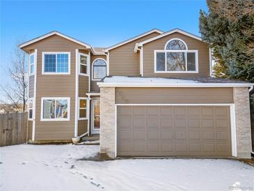 Charming two-story home featuring a brick accent, arched window and an attached two car garage in a quiet neighborhood at 3948 S Halifax St, Aurora, CO 80013