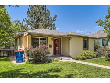 Charming single-story home featuring a well-manicured lawn and a welcoming red front door at 4111 S Delaware St, Englewood, CO 80110