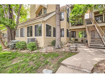 Charming condo building with a private entrance and mature landscaping at 4882 E Kentucky Ave # A, Denver, CO 80246