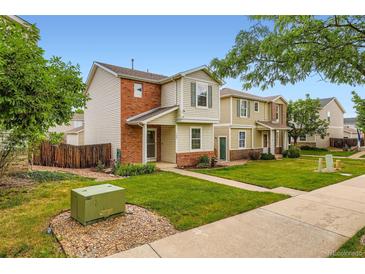 Charming townhome with well-manicured lawn and inviting entrance at 10700 Kimblewyck Cir # 155, Northglenn, CO 80233