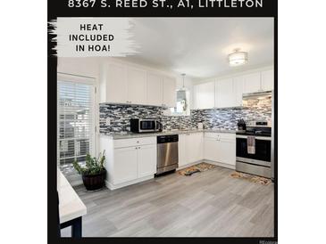 Modern kitchen with stainless steel appliances and granite countertops at 8367 S Reed St # A1, Littleton, CO 80128