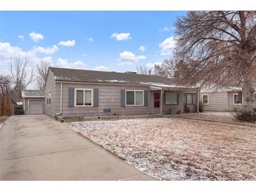 Charming single-story home with a well-maintained front yard and private driveway on a sunny day at 4961 E Cornell Ave, Denver, CO 80222