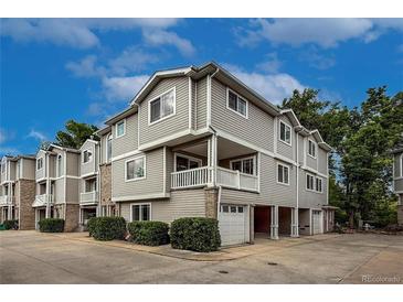 Three-story condo with siding and brick, featuring garage parking and front patio at 4947 Noble Park Pl, Boulder, CO 80301
