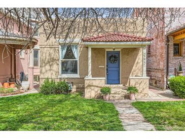 Charming home featuring a blue front door, red-tiled roof, and well-maintained lawn at 2222 N Williams St, Denver, CO 80205
