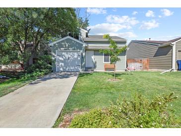 Charming single-story home with manicured lawn, front yard tree, and attached one car garage at 7629 Depew St, Arvada, CO 80003