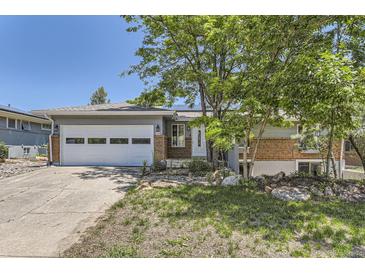 Charming single-story home featuring a brick facade, two car garage, and xeriscaped front yard at 540 Ithaca Dr, Boulder, CO 80305