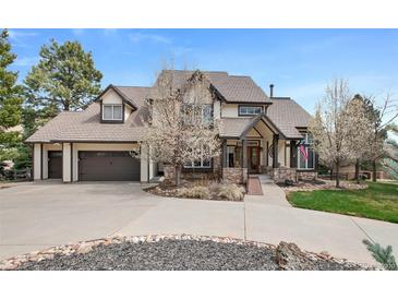 Charming two-story home featuring a well-maintained front yard, a concrete driveway, and an attached garage at 4 White Fir Ct, Littleton, CO 80127