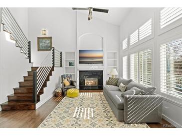 Bright living room with a fireplace, large windows, and elegant decor creating a cozy and inviting space at 2545 Andrew Dr, Superior, CO 80027