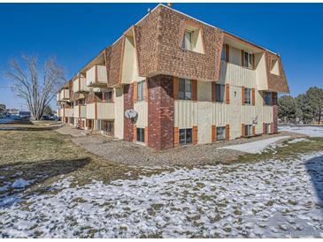 Attractive exterior of a two-story building with a brown roof at 10211 Ura Ln # 7-107, Thornton, CO 80260