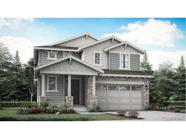 Charming two-story home with stone accents, a covered porch, and a two-car garage at 7397 S Yank Ct, Littleton, CO 80127