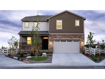 Two-story home boasts mixed siding, stone accents, manicured landscaping, and an attached two-car garage at 1803 S Coolidge St, Aurora, CO 80018