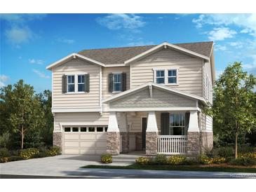 Charming two-story home featuring a covered porch with stone accents and a two-car garage at 20590 E 58Th Ave, Aurora, CO 80019
