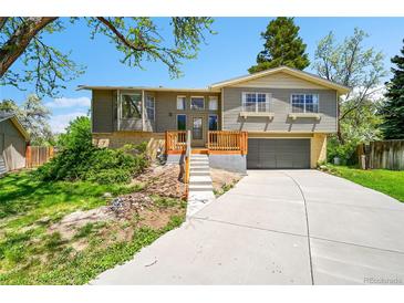 Charming split-level home featuring a newly built deck and attached two-car garage at 7448 W Geddes Pl, Littleton, CO 80128
