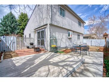 Inviting backyard with a patio, deck, and outdoor seating area for relaxation and entertaining at 1834 Hennington Ct, Longmont, CO 80501