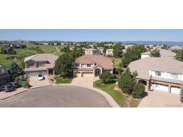 Expansive suburban homes showcase lush landscaping, cul-de-sac, and scenic mountain views at 10085 Charissglen Ct, Highlands Ranch, CO 80126