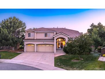 Beautiful two-story home featuring a three-car garage and mature landscaping at 10085 Charissglen Ct, Highlands Ranch, CO 80126