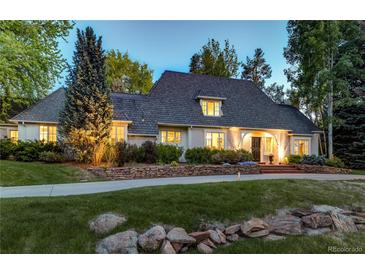 Stately two-story home with lush landscaping and elegant stone accents along the front yard at 1512 Cottonwood Ln, Greenwood Village, CO 80121