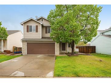 Charming two-story home with a well-manicured lawn and a spacious driveway leading to a two-car garage at 13504 Pecos St, Westminster, CO 80234