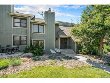 Charming townhouse showcasing a welcoming front exterior, landscaped yard, and inviting entrance with seating at 19 Benthaven Pl, Boulder, CO 80305